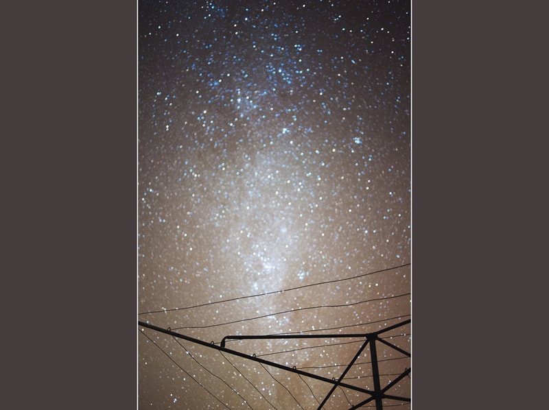 A long exposure of the night sky and stars with a hills hoist in the foreground at my grandpas house